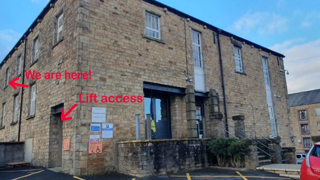 An image of a car park and the top entrance of Harpers Mill